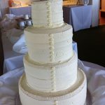 white cake with buttons like a dress