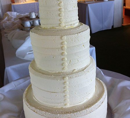 white cake with buttons like a dress