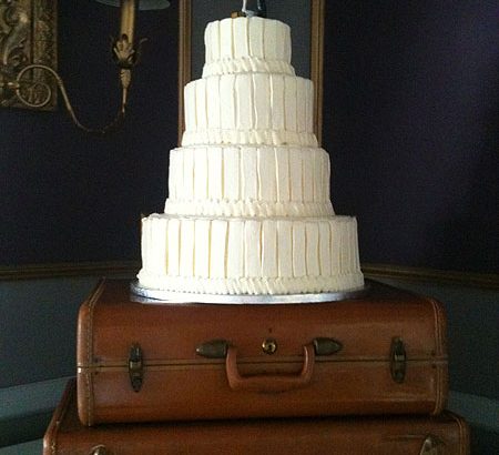 white wedding cake on suitcases