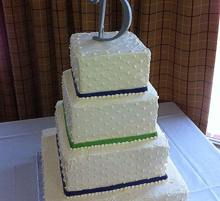 white and blue wedding cake with a D