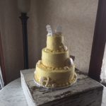 yellow cake with beach chairs on top